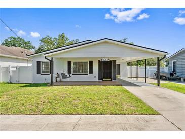 Charming single-story home with a well-maintained lawn and a convenient carport at 1623 Cumbie Ave, Orlando, FL 32804