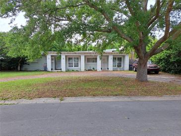Charming single-story home featuring dual entryways, brick driveway, and mature tree providing ample shade at 1773 Walnut Ave, Winter Park, FL 32789