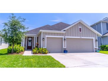 Charming single-Gathering home featuring a two-car garage, well-manicured lawn, and inviting front entryway at 17840 Passionflower Cir, Clermont, FL 34714
