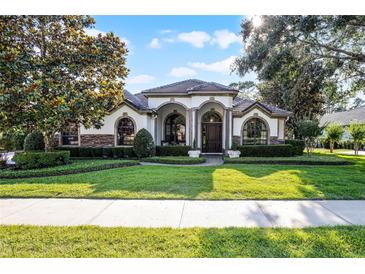 Charming one-story home with arched entryways, manicured landscaping, and a well-maintained lawn at 190 Osprey Hammock Trl, Sanford, FL 32771