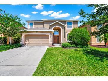 Charming two-story home with a well-manicured lawn and inviting curb appeal on a beautiful day at 2209 Crofton Ave, Davenport, FL 33837