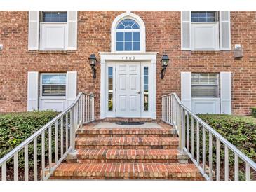A beautiful brick house with a white front door, flanked by white-framed windows, and a lovely brick stairway entrance at 4306 Lake Underhill Rd # C, Orlando, FL 32803