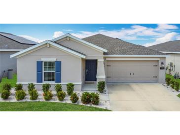 Charming single-story home with a well-manicured lawn and two-car garage in a sunny, vibrant neighborhood at 1120 Saguaro St, Haines City, FL 33844