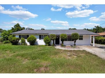 Charming single-story home with a well-maintained lawn and inviting front entrance at 1216 Floral Way, Apopka, FL 32703