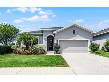 Charming single-story home with a well-manicured lawn and inviting curb appeal at 17200 Gathering Place Cir, Clermont, FL 34711