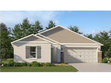 Charming single-story home featuring neutral paint, gabled roof, 2-car garage, and professionally landscaped front yard at 4309 Riverbend Blvd, Haines City, FL 33844