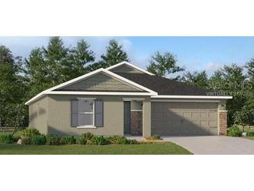 Charming single-story home featuring a two-car garage and professionally landscaped front yard at 4313 Riverbend Blvd, Haines City, FL 33844