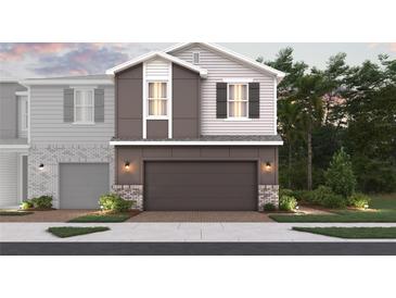 Modern two-story home with a gray color scheme, a two-car garage, and manicured landscaping at 564 Southern Edge Way, Sanford, FL 32771