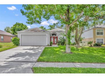 Charming single-story home featuring a well-manicured lawn and a two-car garage in a quiet neighborhood at 1181 Welch Hill Cir, Apopka, FL 32712