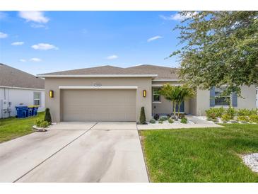 Charming single-Gathering home featuring a two-car garage, landscaped yard, and a cozy front porch at 15356 White Tail Loop, Mascotte, FL 34753