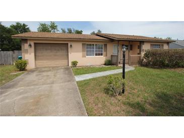 Charming single-Gathering home featuring a driveway, a well-kept lawn, and a cozy front porch at 2013 Dearing Ave, Deltona, FL 32725
