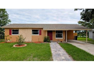 Charming single-story home featuring a well-manicured lawn and a brick pathway leading to the front door at 331 Greens End St, Orlando, FL 32810