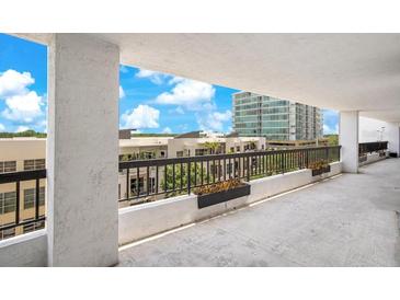 This balcony features decorative flower boxes and an open view to the exterior landscaping at 530 E Central Blvd # 406, Orlando, FL 32801