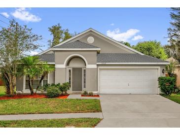 Charming single Gathering home featuring a two-car garage and well-manicured lawn at 10930 Buckwater Ct, Orlando, FL 32817