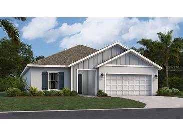 Charming one-story home featuring a well-maintained lawn, two car garage, and light gray stucco exterior at 415 Puma Loop, Groveland, FL 34736