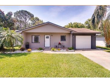 Charming single-story home with well-maintained lawn, landscaping, and a one car garage at 5216 Sunrise Blvd, Orlando, FL 32803