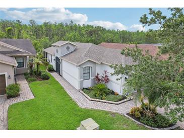 Charming single-story home featuring manicured landscaping and a welcoming walkway leading to the front entrance at 636 Grand Canal Dr, Kissimmee, FL 34759