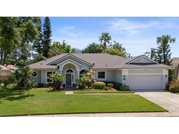 Charming single-story home featuring manicured lawn and inviting covered entryway at 1107 Almond Tree Cir, Orlando, FL 32835