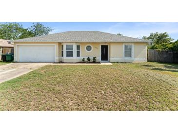 Charming single-story home with a well-maintained lawn and attached two-car garage at 3342 Sanborn Ln, Deltona, FL 32738