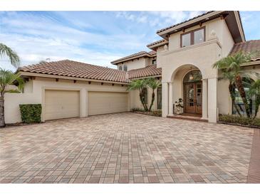 Stunning two-story home boasts a three-car garage and a beautiful tile roof, perfect for luxury living at 4031 Bermuda Grove Pl, Longwood, FL 32779