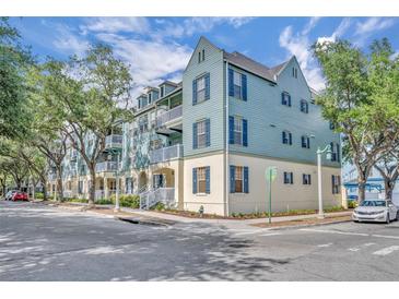 Attractive three-story building with balconies, blue shutters and a street view at 611 Campus St # 160, Celebration, FL 34747