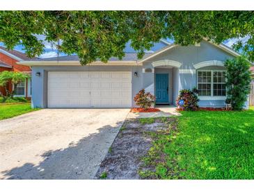 Charming single-story home with a well-manicured lawn, blue exterior, and a two-car garage at 3010 Egrets Landing Dr, Lake Mary, FL 32746