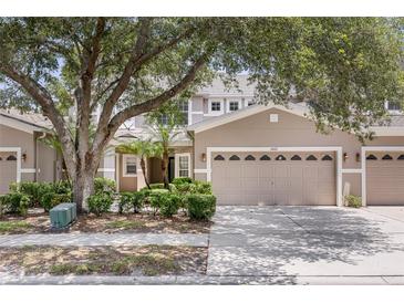 Charming townhome featuring a neutral color scheme, a two-car garage, and lush landscaping in a well-maintained community at 1062 Wickerwood St, Ocoee, FL 34761