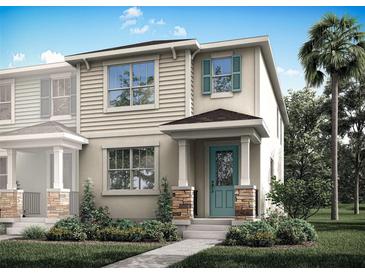 Charming two-story home featuring a quaint porch, stone accents, manicured landscaping, and a refreshing teal front door at 1315 Tarflower Dr, Winter Springs, FL 32708