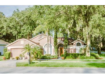 Charming single-Gathering home with lush landscaping and mature trees at 2102 Applegate Dr, Ocoee, FL 34761