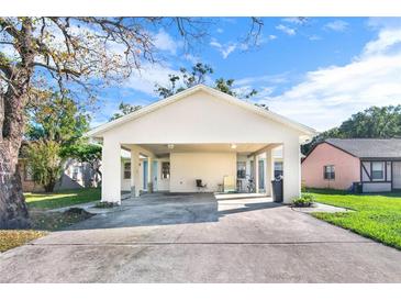 Charming single-story home showcasing a covered carport with a spacious concrete driveway at 2417 Cedar Ave, Sanford, FL 32771