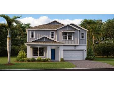 Charming two-story home with a well-manicured lawn and attached two car garage at 2871 Haze Rd, Clermont, FL 34714