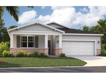 Charming single-story home with stone accents, a two-car garage, and a beautifully landscaped front yard at 4136 Lavender Ct, Lake Hamilton, FL 33851