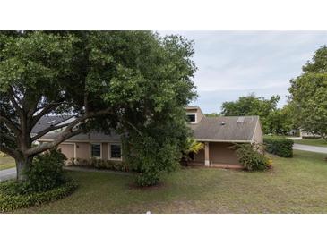 Inviting single-Gathering home featuring an attached two-car garage and lush landscaping, creating a welcoming curb appeal at 6047 Shore Line Dr, Orlando, FL 32819