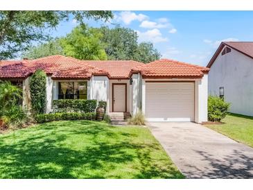 Charming single-story home featuring a red tile roof and a well-manicured front lawn at 631 Warrenton Rd, Winter Park, FL 32792