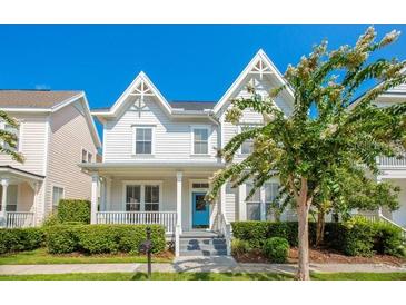 Charming two-story home with a well-maintained front yard and inviting curb appeal at 1222 Golden Canna Ln, Celebration, FL 34747