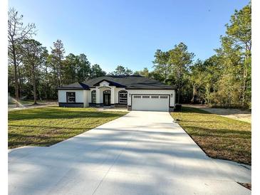 Stunning single Gathering home featuring a wide driveway and a two-car garage at 13619 Sw 78Th Place, Dunnellon, FL 34432