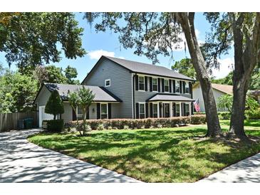 Charming two-story home with a well-manicured lawn and black shutters at 1462 Mt Laurel Dr, Winter Springs, FL 32708