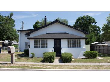Charming one-story home featuring a black door, black roof and white exterior at 161 Bolender Rd, Auburndale, FL 33823