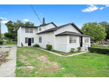Rear exterior view of a two-story home with a large yard, showcasing the architectural details at 161 Bolender Rd, Auburndale, FL 33823