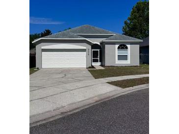 Charming single-story home featuring a two-car garage, neutral paint, and well-maintained landscaping at 2049 Crosscreek Ct, Oviedo, FL 32766