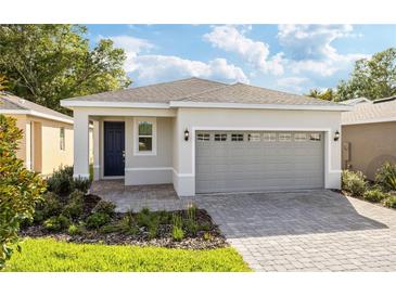 Charming single-Gathering home featuring a gray garage door and landscaped front yard at 150 Fredericksburg Ave, Orange City, FL 32763