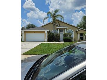 Charming single-story home with a well-manicured lawn and a mature palm tree at 1710 Canoe Creek Rd, Oviedo, FL 32766