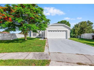 Charming single-story home featuring a well-manicured lawn and an attached two-car garage at 2301 Finwick Ct, Kissimmee, FL 34743