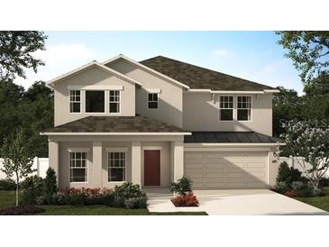 Charming two-story home featuring a neutral palette, well-manicured landscaping, attached two car garage and classic architectural details at 443 Lemongrass Rd, Minneola, FL 34715