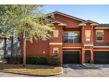 Inviting exterior of a two-story townhome featuring a one-car garage and landscaping at 191 Villa Di Este Ter # 201, Lake Mary, FL 32746
