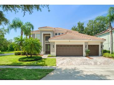 Beautiful two-story home featuring a three-car garage, tile roof, and well-maintained landscaping at 390 Anessa Rose Loop, Ocoee, FL 34761