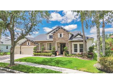 Charming home featuring stone accents, lush landscaping, and a well-manicured lawn at 5944 Lake Melrose Dr, Orlando, FL 32829