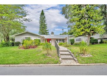 Charming single-story home with a well-manicured lawn and landscaped garden, enhancing its curb appeal at 604 Ponca Trl, Maitland, FL 32751