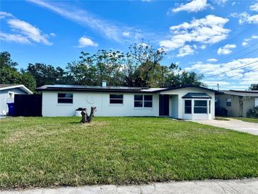 Charming single-story home with fresh exterior paint and a well-manicured lawn on a sunny day at 804 Starke Lake Cir, Ocoee, FL 34761