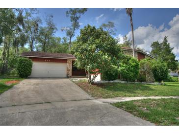 Charming single-story home with a stone facade, mature trees, and a well-maintained front yard at 916 Great Bend Rd, Altamonte Springs, FL 32714
